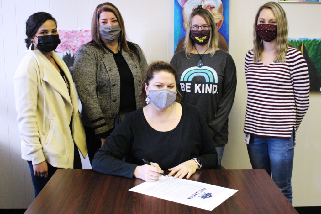 Three of the 15 school counselors met at the Marshall County Schools Board of Education office for the proclamation signing. Those who attended are pictured with county administrators. Seated is MCS Superintendent Dr. Shelby Haines. Standing, from left, are Mia Angalich (JM), MCS Student Services Director Karen Klamut, Jennifer Pickett (MPS) and Jenna Dompa (CES).