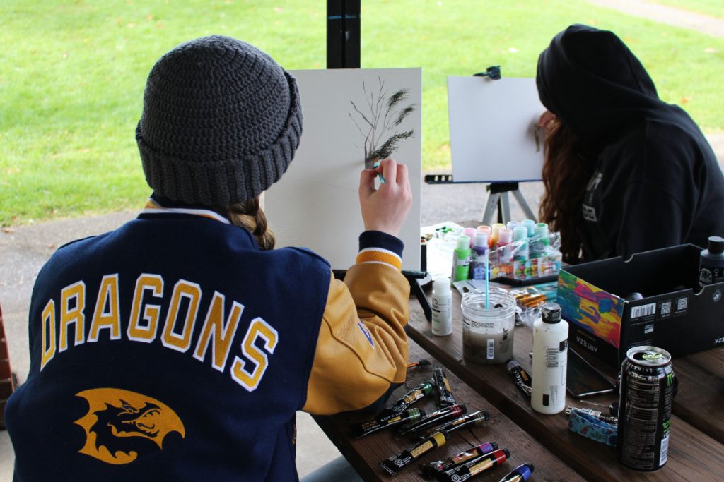 Pictured from left: CHS senior Kaylee Strope and CHS junior Caitlyn Conner show off their artists skills at the Ohio Valley Plein Air Paint Out.