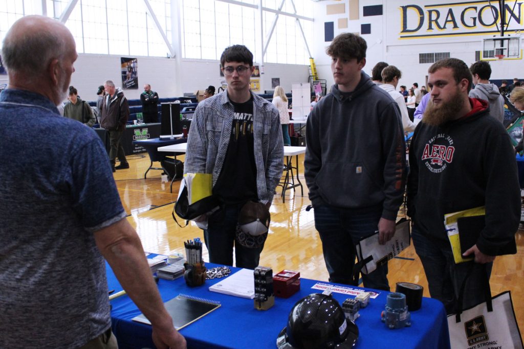 Pictured from left: International Brotherhood of Electrical Workers (IBEW) Local Union 141 lead organizer Dan Morris explains the organization’s apprenticeship programs to Cameron High School seniors David Streight, David White and Nicholas Strope.